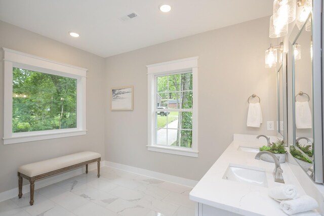 bathroom with dual bowl vanity and tile flooring