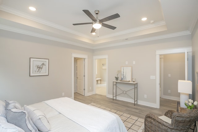 bedroom featuring ceiling fan, a raised ceiling, crown molding, and light wood-type flooring