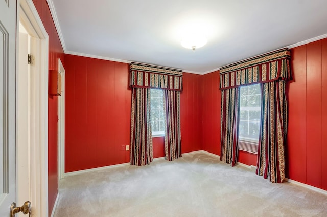 carpeted empty room featuring ornamental molding