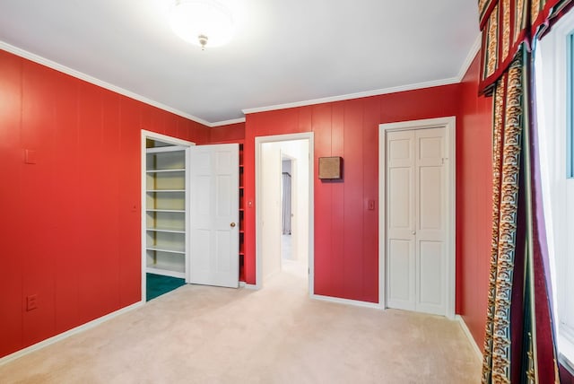 unfurnished bedroom featuring carpet and crown molding