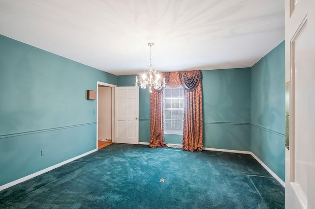 carpeted empty room featuring a chandelier