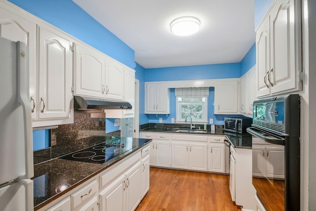 kitchen with sink, white cabinets, black appliances, and light wood-type flooring