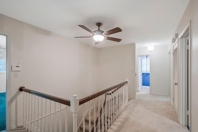 hall with light colored carpet