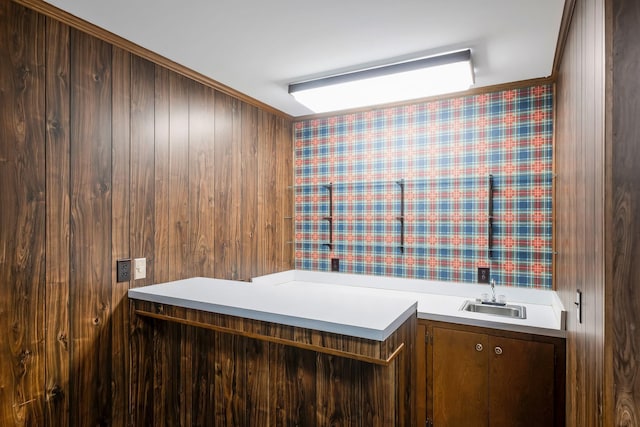 bathroom with vanity, wooden walls, and ornamental molding