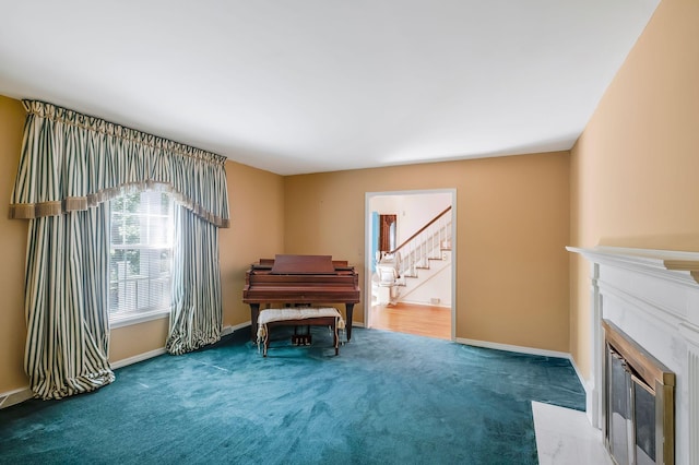 misc room featuring a fireplace and carpet