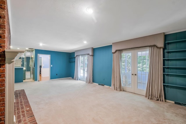 unfurnished living room with french doors and carpet floors