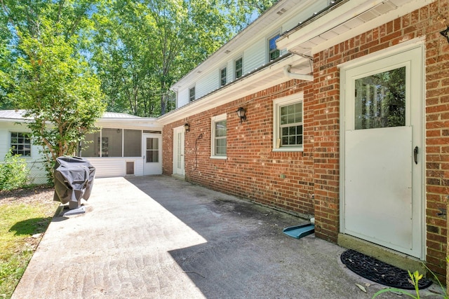 view of patio featuring a sunroom and area for grilling