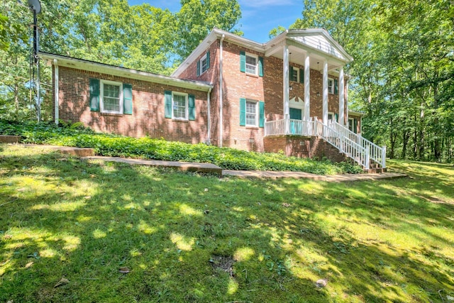 greek revival inspired property featuring a porch and a front lawn