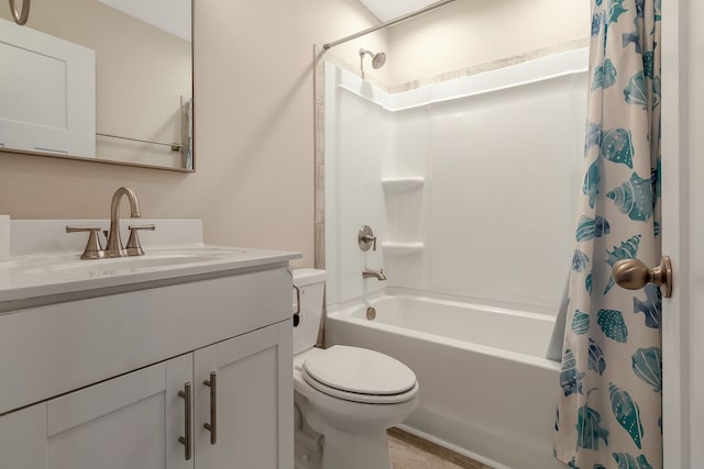 full bathroom featuring large vanity, hardwood / wood-style flooring, toilet, and shower / tub combo