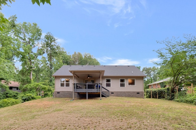 back of house with a lawn, a wooden deck, and ceiling fan