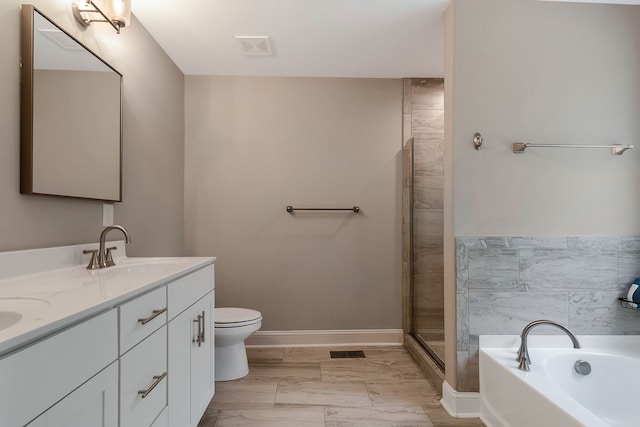 full bathroom with double vanity, separate shower and tub, and toilet