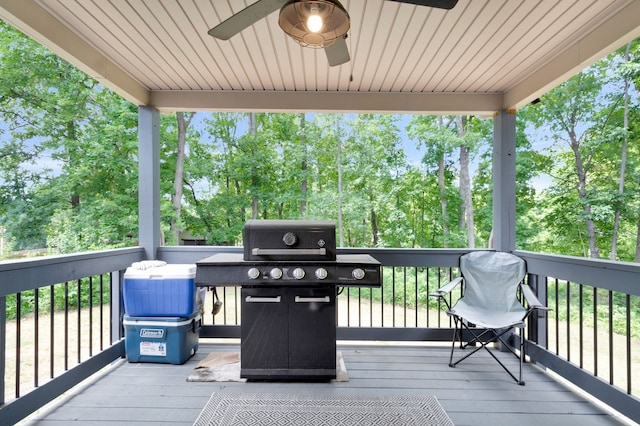 deck featuring area for grilling and ceiling fan