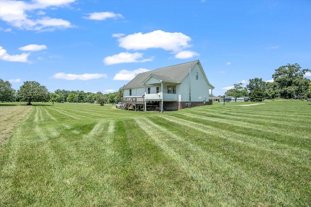 view of yard with a rural view and a deck