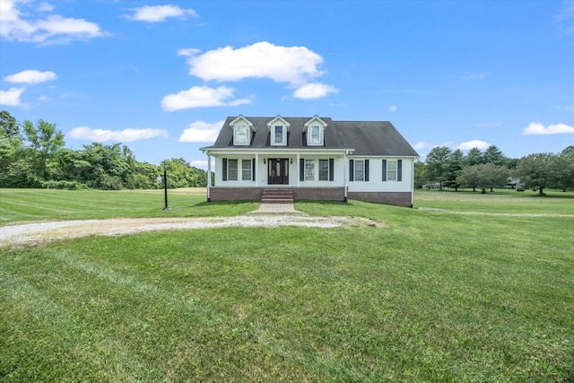 new england style home featuring a porch and a front lawn