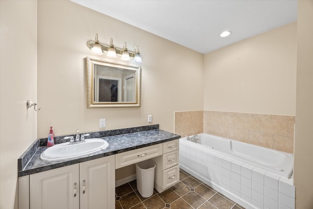 bathroom featuring tile patterned flooring, vanity, and a relaxing tiled tub