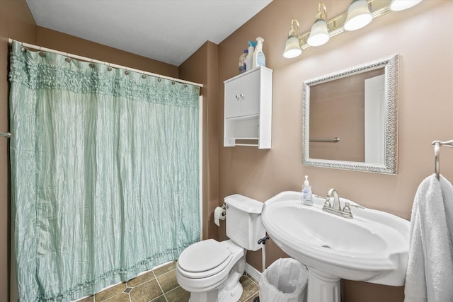 bathroom featuring tile patterned flooring, toilet, sink, and a shower with shower curtain