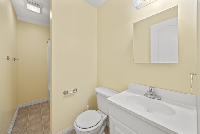 bathroom featuring tile patterned flooring, vanity, and toilet