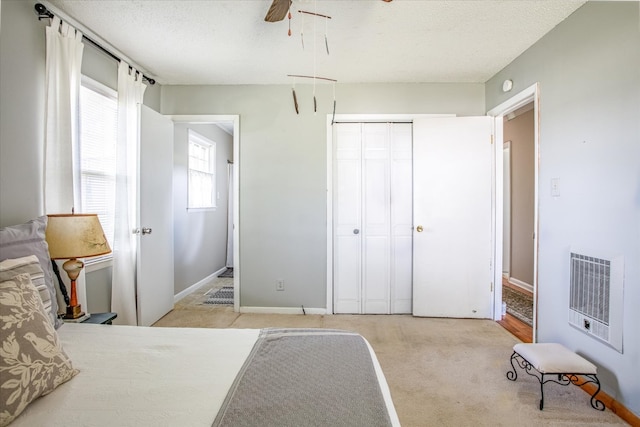 carpeted bedroom with a closet and ceiling fan