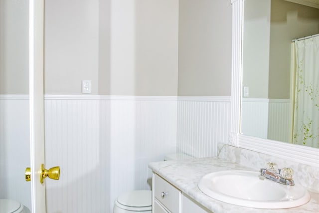 bathroom featuring toilet and vanity