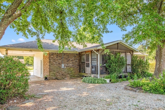 view of front of home featuring a sunroom