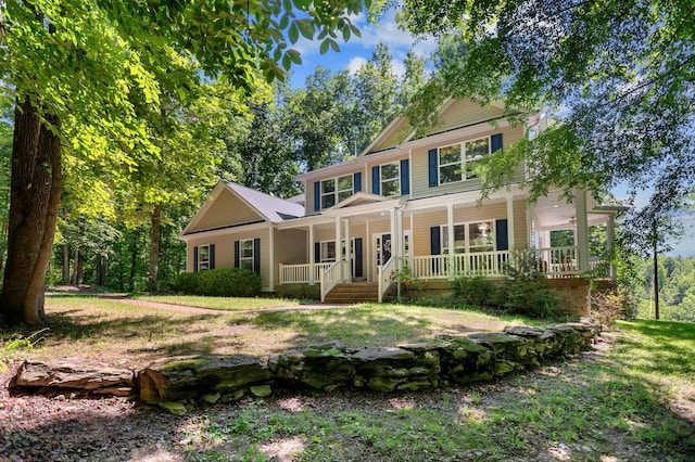 colonial home featuring a front yard and covered porch