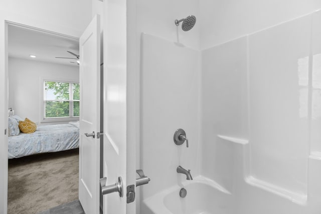 bathroom featuring ceiling fan and bathing tub / shower combination