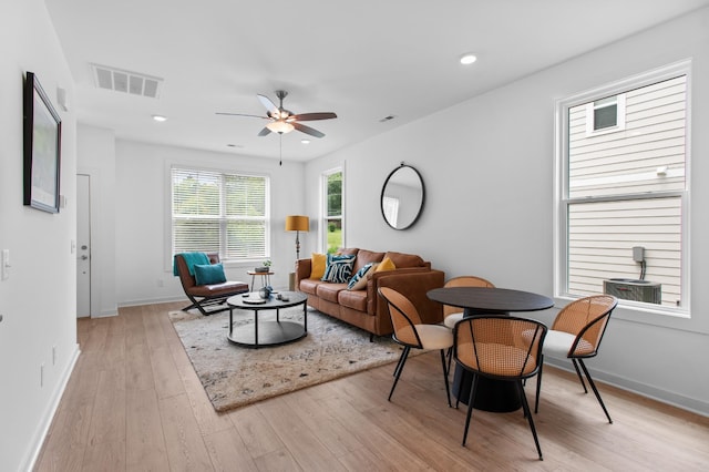 living room with light wood-type flooring and ceiling fan