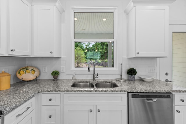 kitchen with dishwasher, white cabinetry, and sink