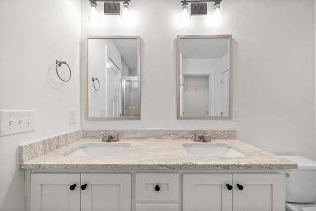 bathroom with walk in shower and vanity