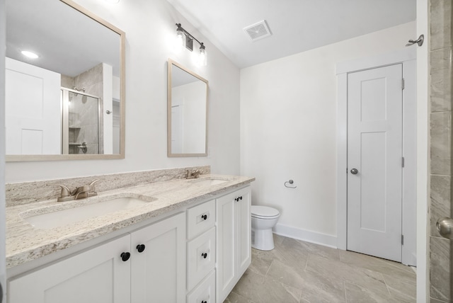 bathroom with a shower with door, vanity, and toilet