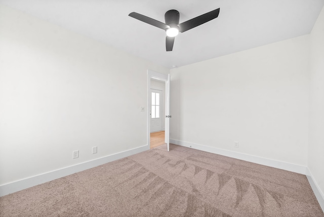 carpeted spare room with ceiling fan