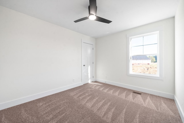 spare room featuring carpet and ceiling fan