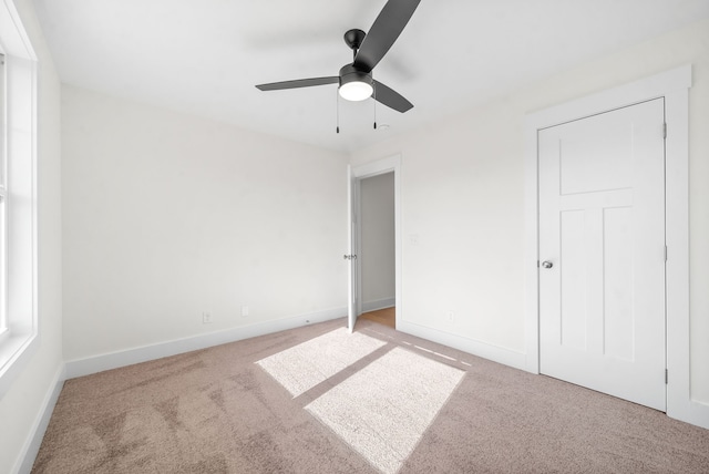 unfurnished bedroom featuring carpet floors and ceiling fan