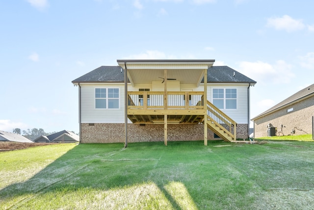 rear view of house featuring a wooden deck, ceiling fan, a lawn, and central air condition unit