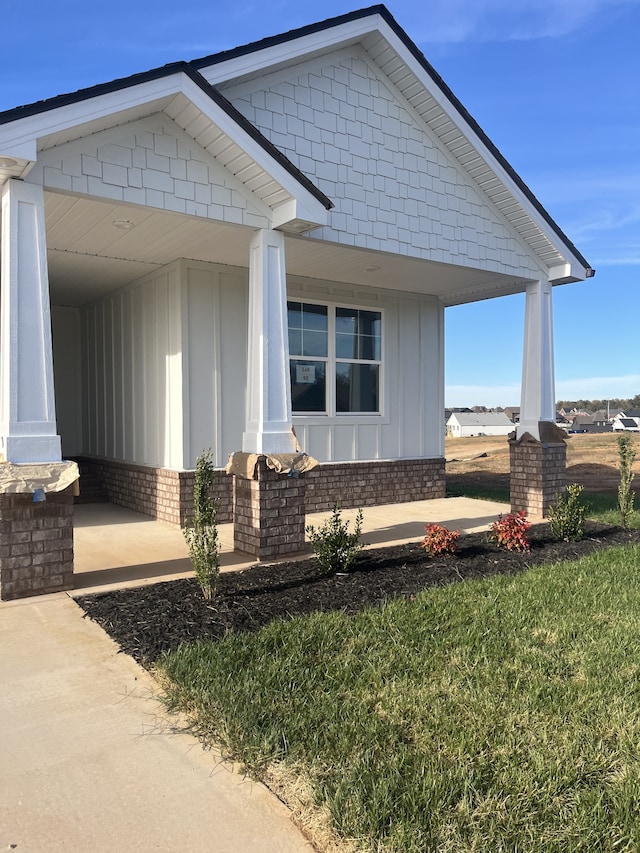 view of side of property with a lawn