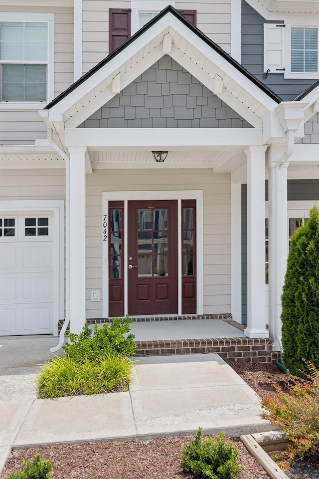 view of exterior entry with a porch