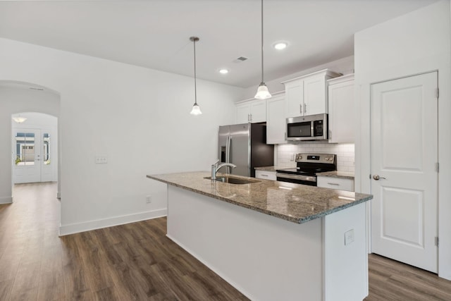 kitchen with white cabinetry, a kitchen island with sink, sink, appliances with stainless steel finishes, and pendant lighting