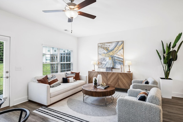 living room featuring ceiling fan, plenty of natural light, and dark hardwood / wood-style floors