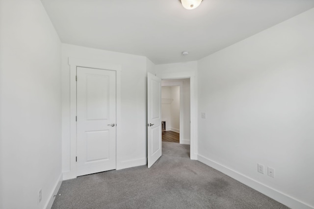 unfurnished bedroom with carpet flooring and a closet