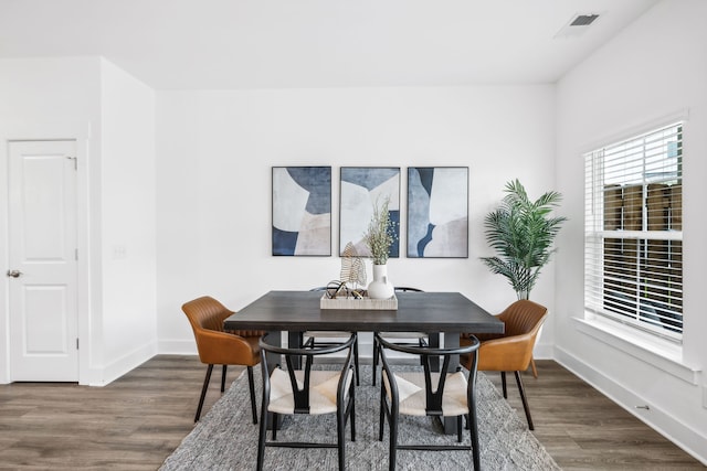 dining area with dark hardwood / wood-style flooring