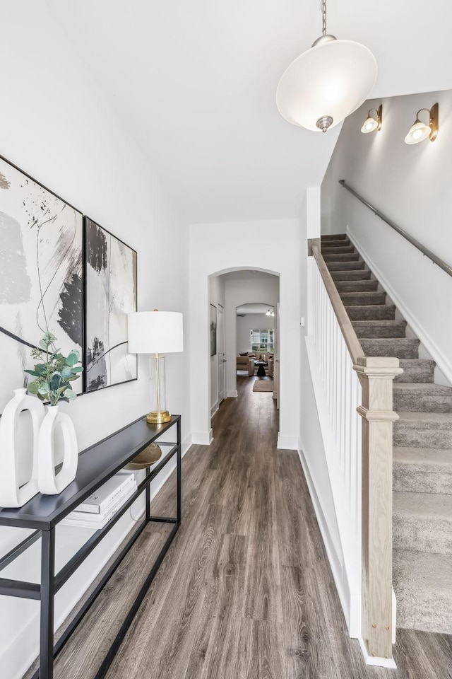 hallway with dark hardwood / wood-style flooring