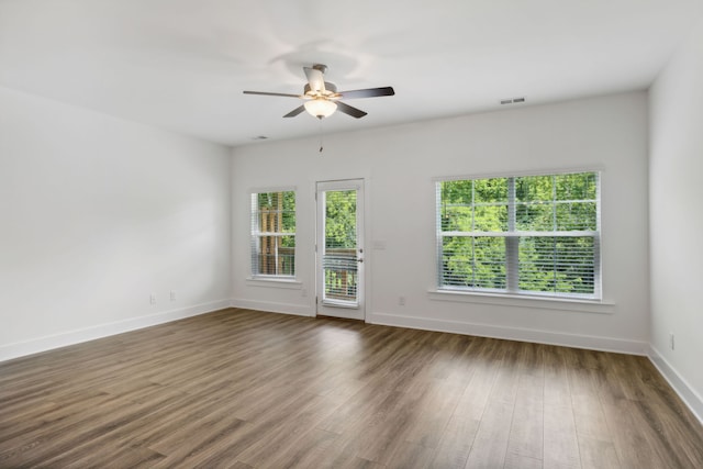 empty room with ceiling fan and hardwood / wood-style floors