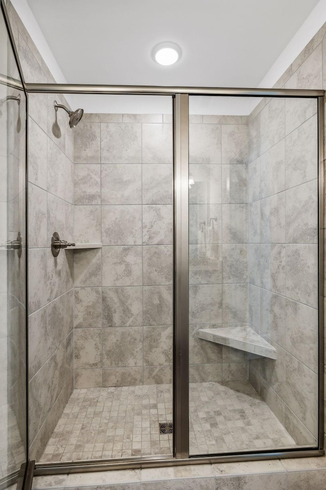 bathroom with a shower with door