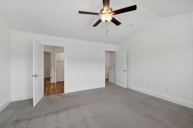 unfurnished bedroom with carpet floors, vaulted ceiling, and ceiling fan