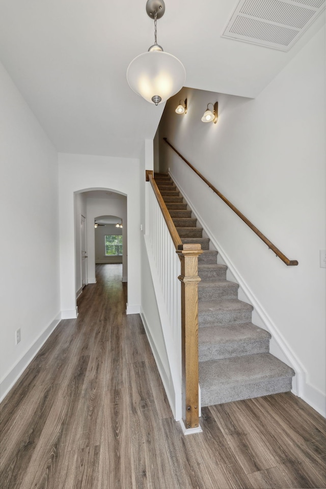 stairway with hardwood / wood-style floors