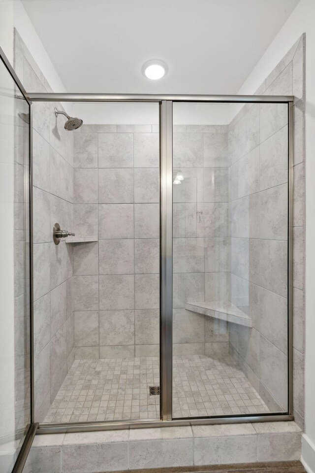 bathroom with a shower with shower door