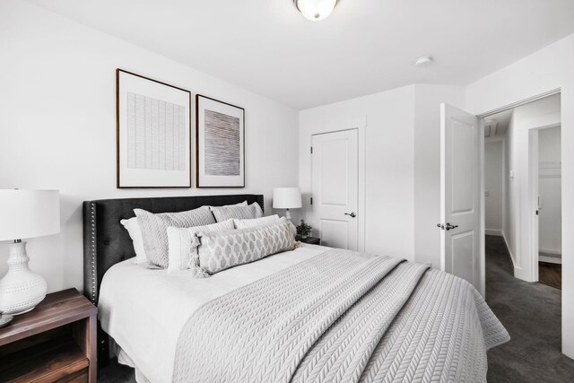 bedroom featuring dark carpet