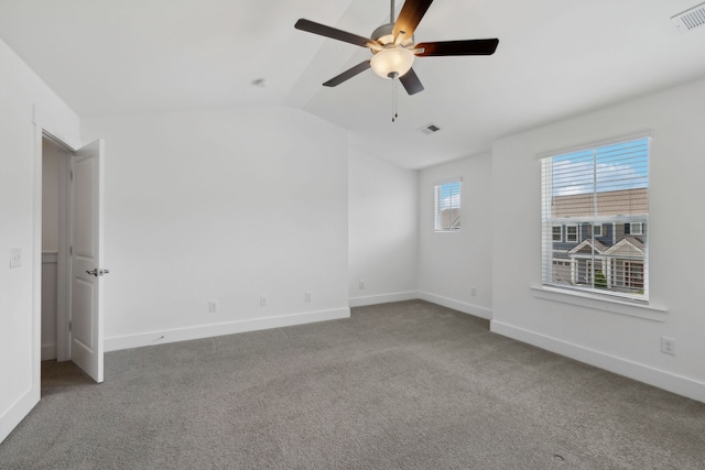 carpeted empty room featuring ceiling fan and lofted ceiling