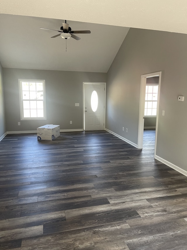 foyer featuring a healthy amount of sunlight, ceiling fan, vaulted ceiling, and dark hardwood / wood-style floors