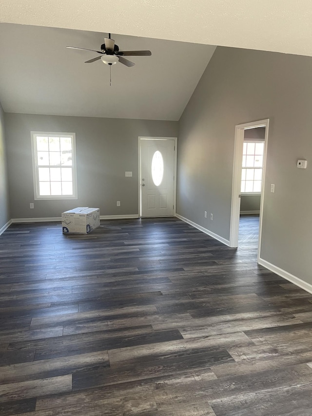 entryway featuring baseboards, dark wood-style flooring, ceiling fan, and vaulted ceiling